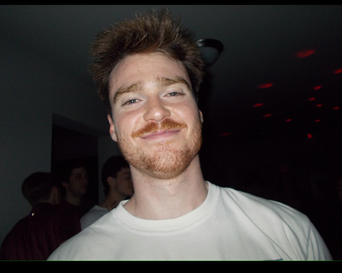 A tennis player serving on a grass court